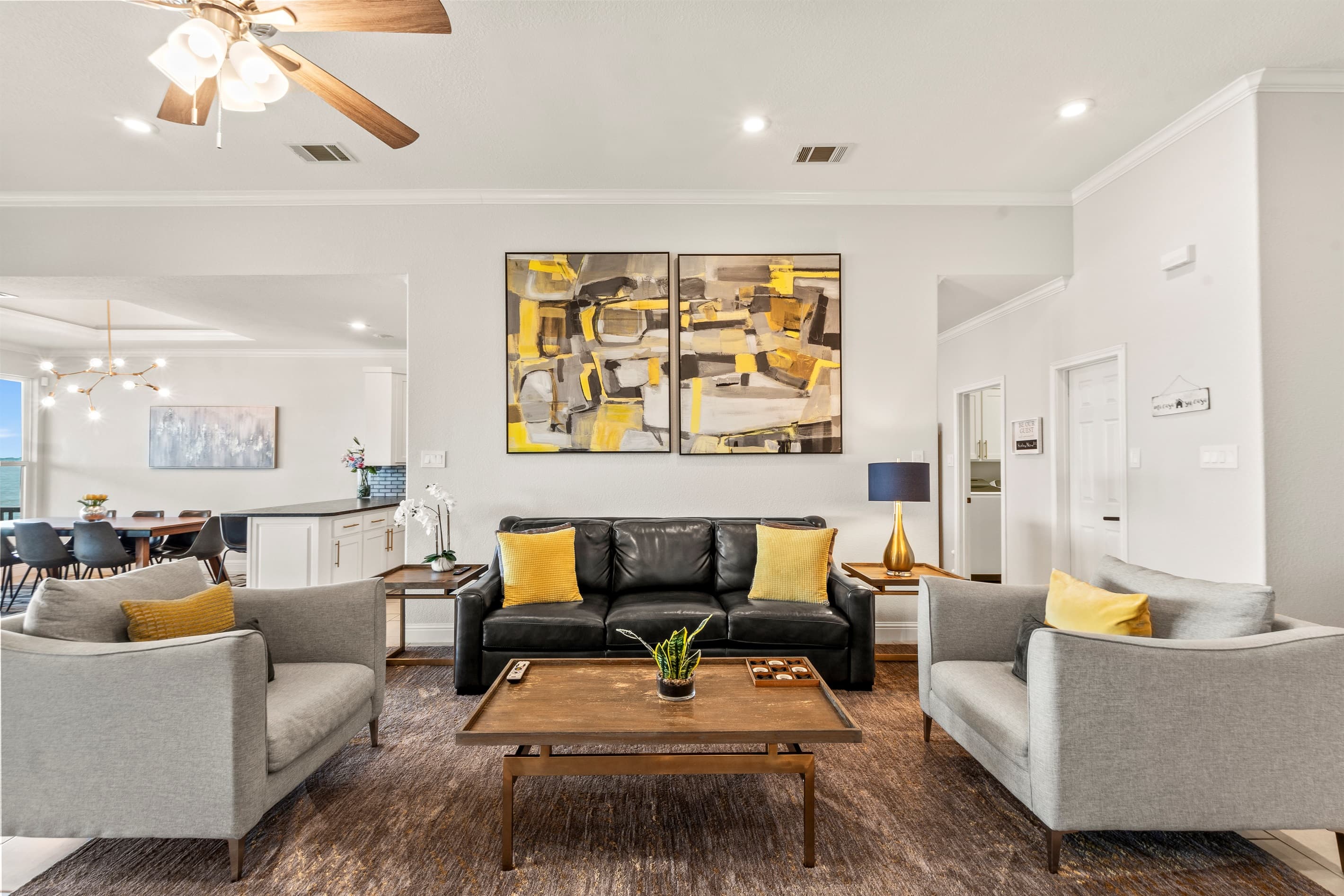 A view of comfortable furniture in the family room and living room with expansive windows with open water views!