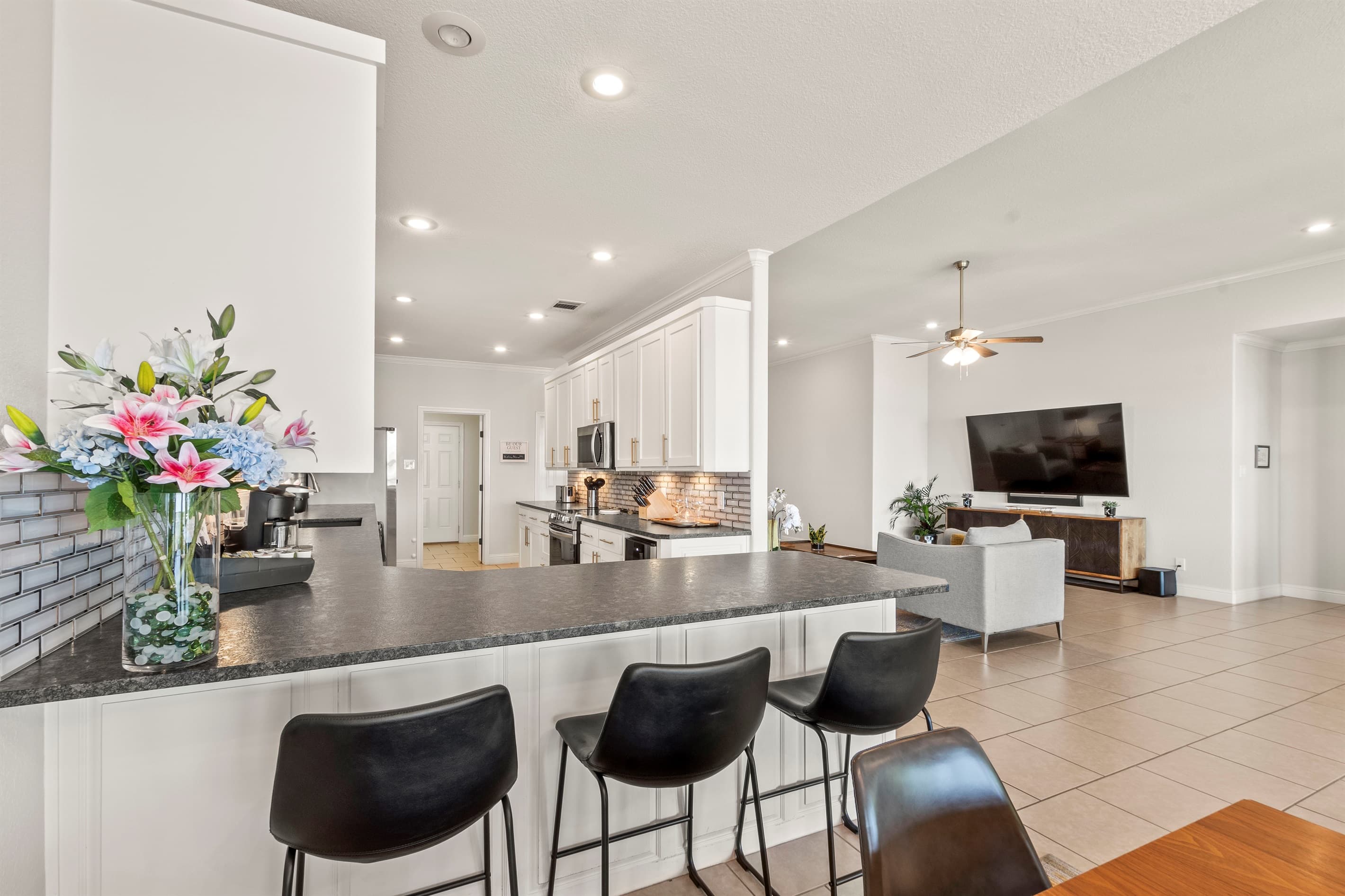 Open-concept living room and kitchen designed for comfort and connection—perfect for relaxing, cooking, and entertaining with ease.