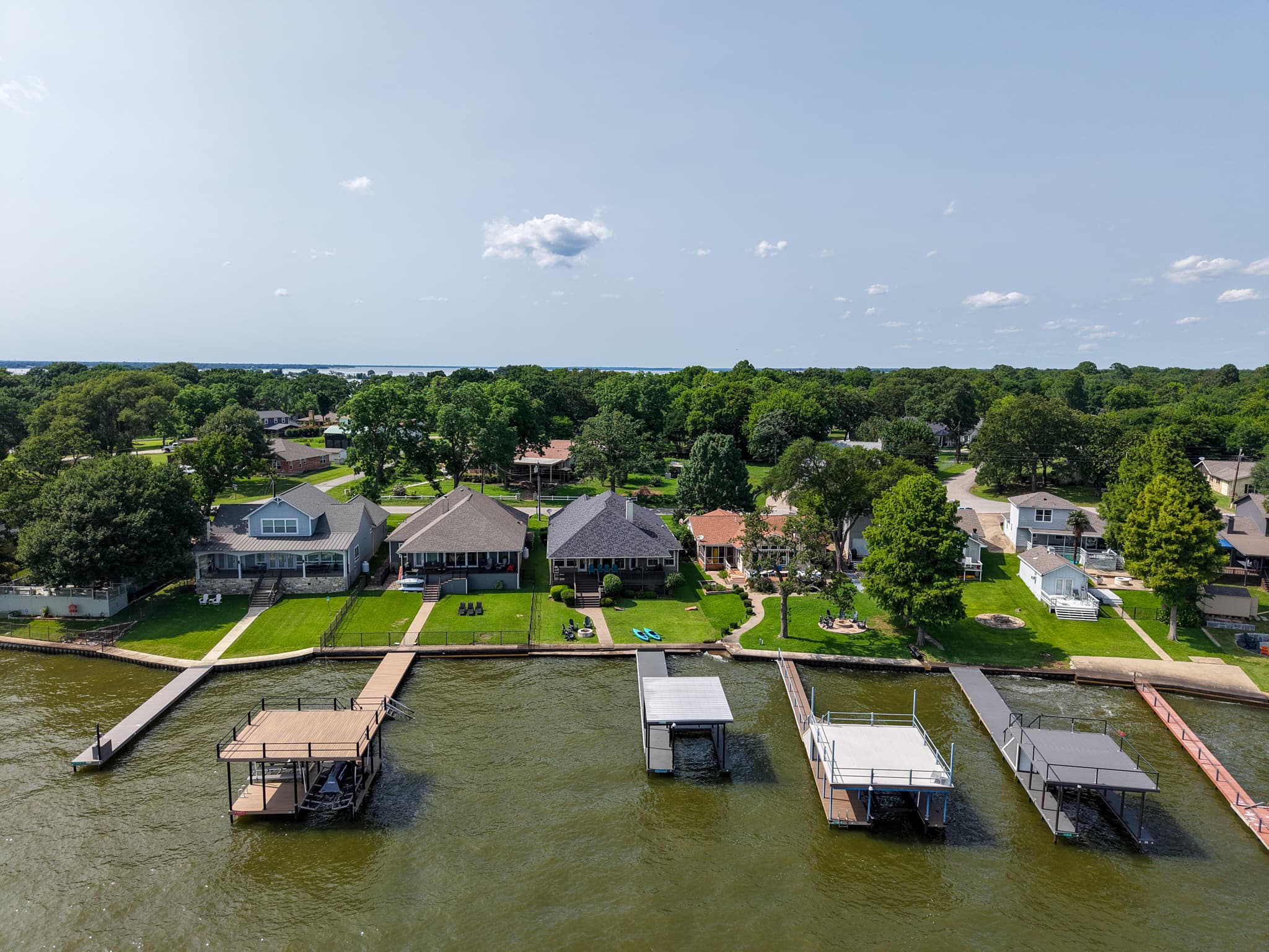 A view even the birds envy—captured from behind the dock, looking back at the spacious yard and inviting home.