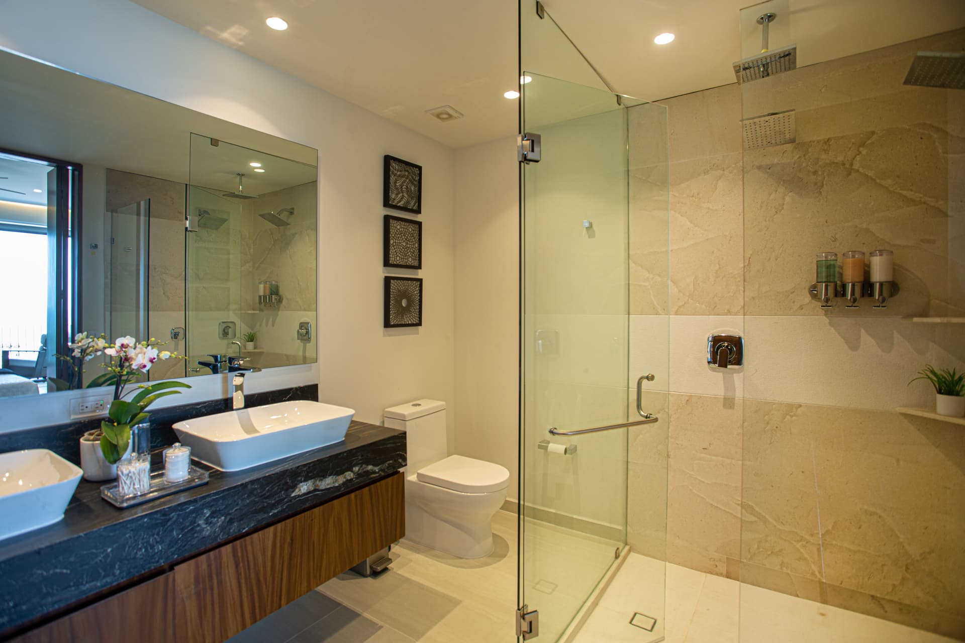 The primary bathroom features double sinks, a spacious double shower with both a rainshower and wall shower, and ample closet space, giving guests everything they need.