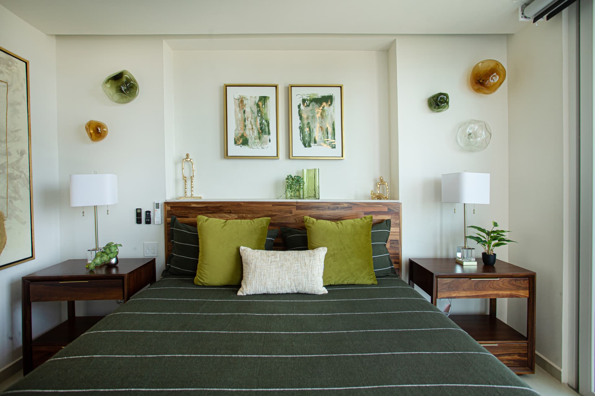 Spacious guest bedroom (#1) with ensuite bath, generous closet and storage space, and private access to one balcony and shared access to another—perfect for relaxing in swivel chairs with a book and enjoying ocean views.