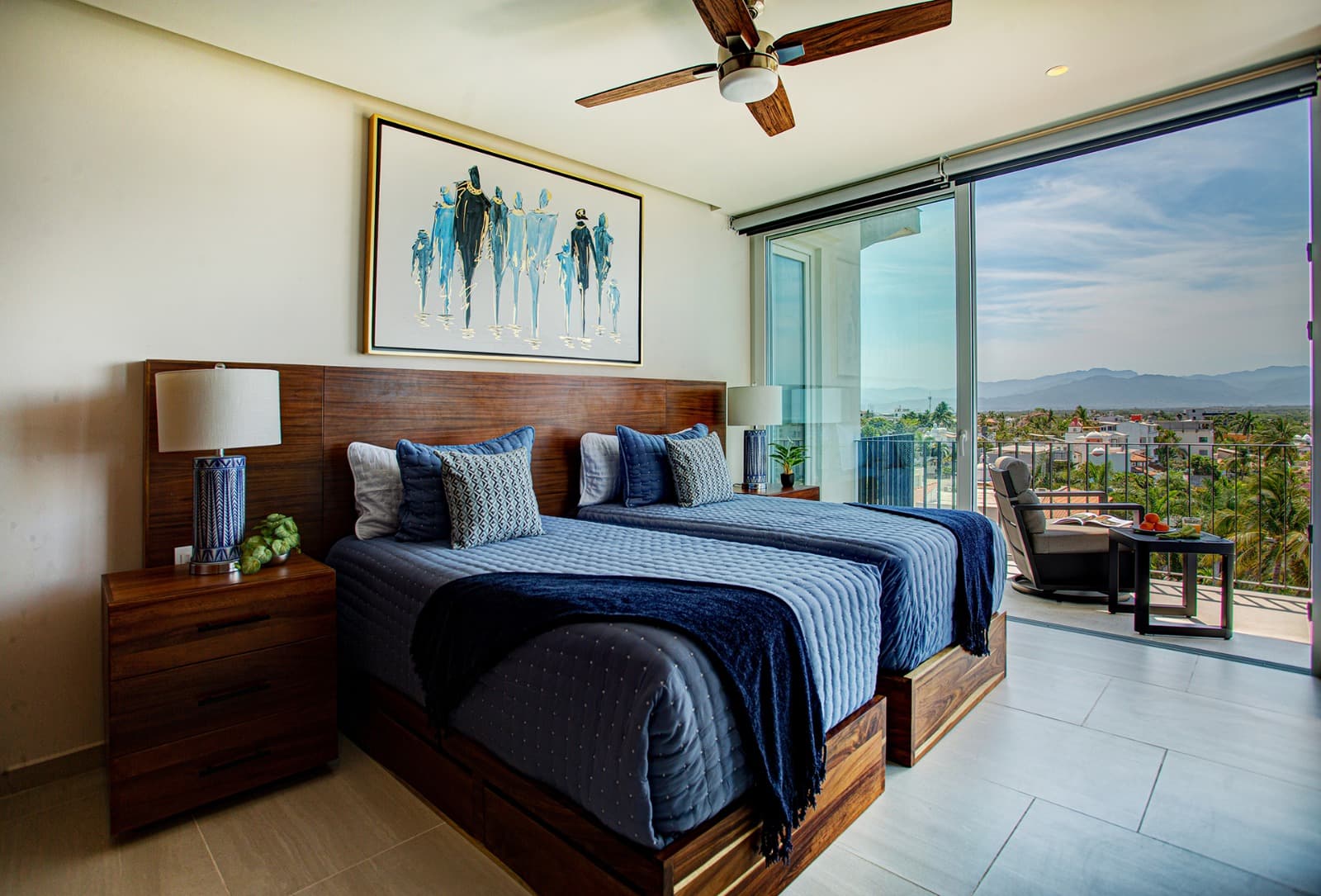 Guest Bedroom 2 is spacious and filled with natural light, offering beautiful views and a balcony. The bed can be configured as either two twins or one king, and a 55-inch TV makes it perfect for relaxing after a day out.