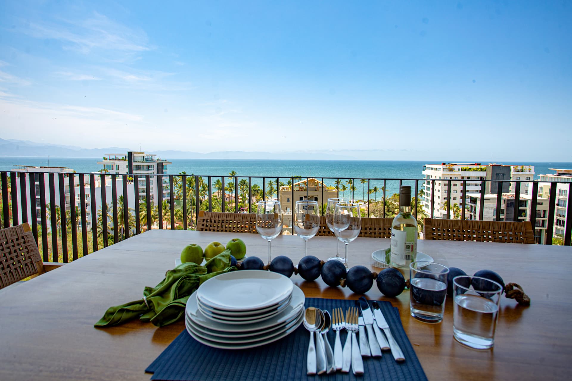 The large wraparound balcony is a standout feature with stunning ocean and mountain views and dining seating for 8.  