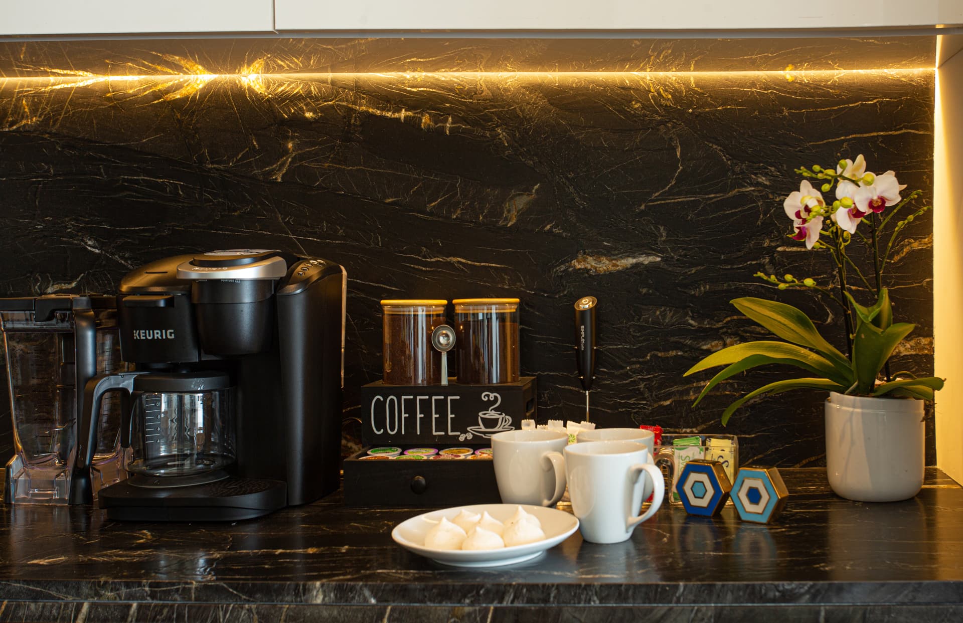 Coffee bar stocked with regular and decaf coffee, a selection of Keurig K-cups, plus sugar and cream—everything you need to start your day right.