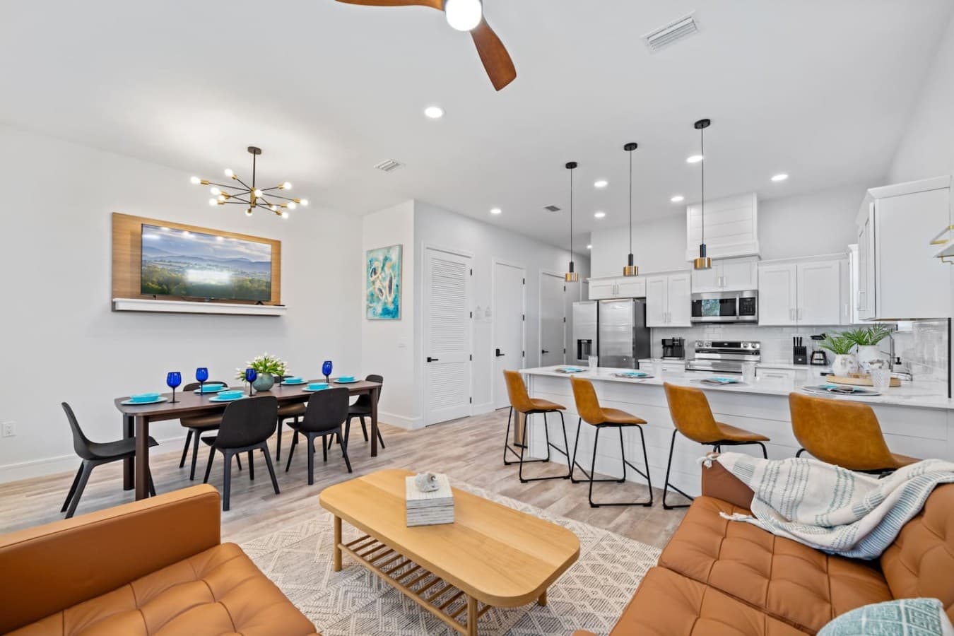 An open floor plan with dining table, living room and kitchen all adjacent to each other (downstairs)