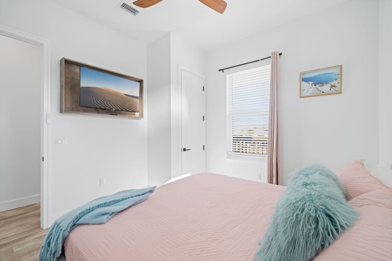 King bedroom upstairs with a large smart TV