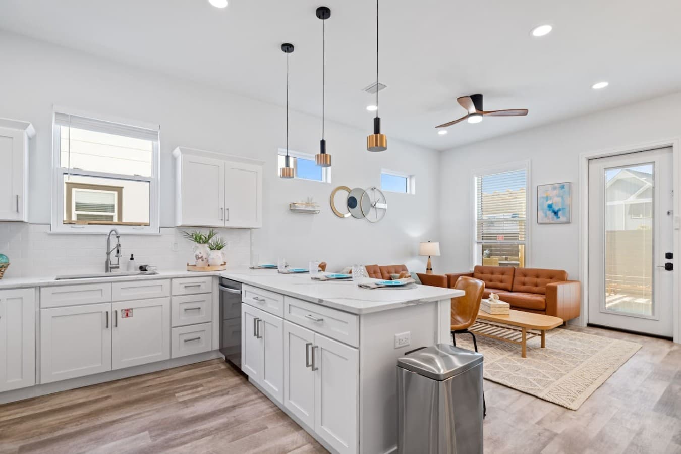 The kitchen is located downstairs in the home and next to the dining and living room