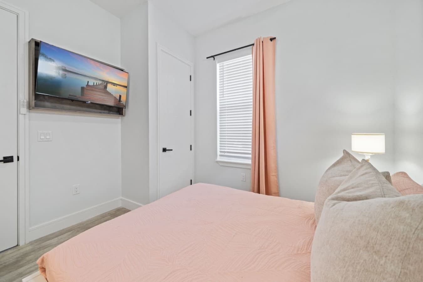 Queen bedroom upstairs in the home with a large smart TV