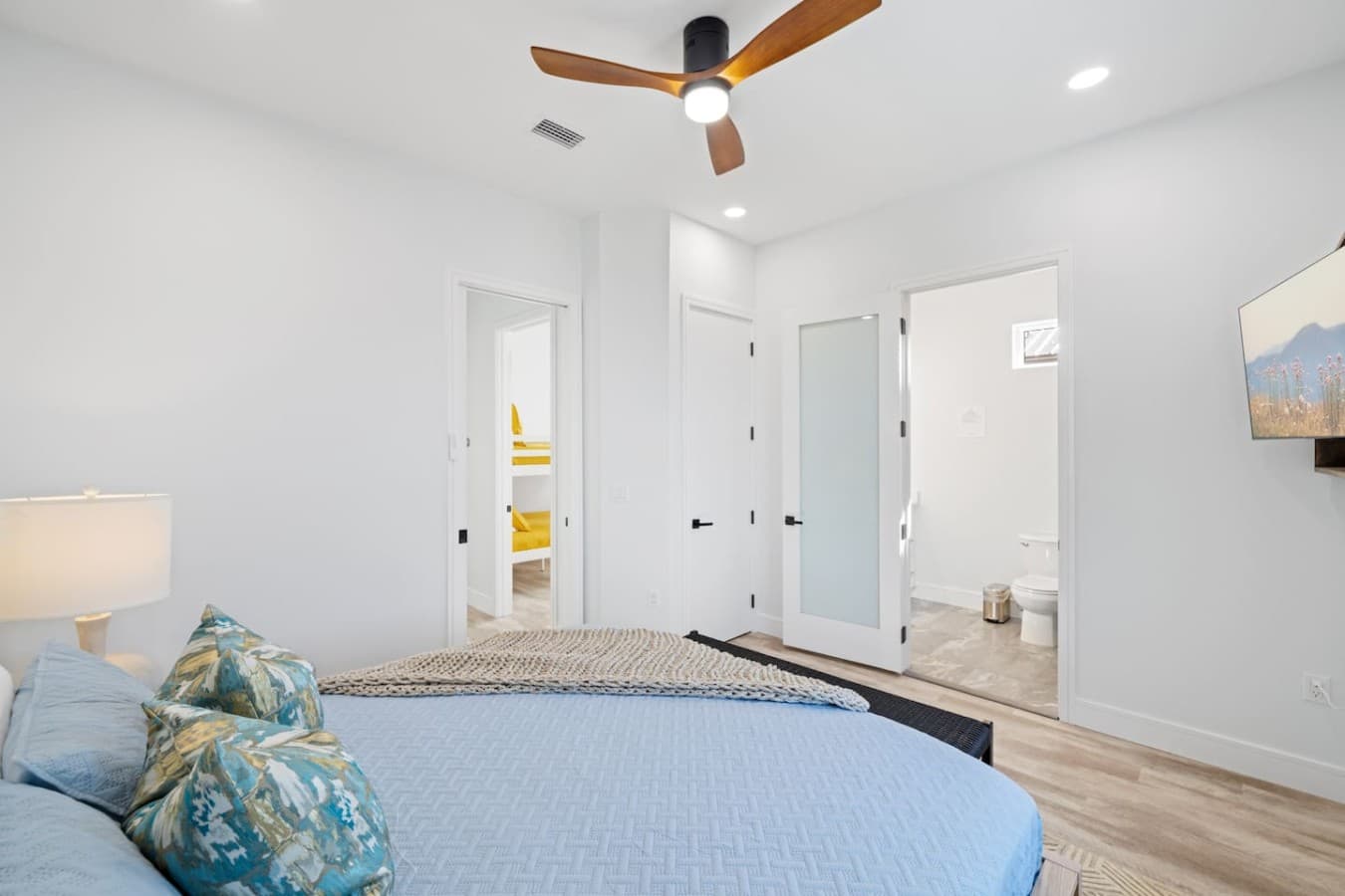 Master bedroom with en suite bathroom located upstairs in the two level home