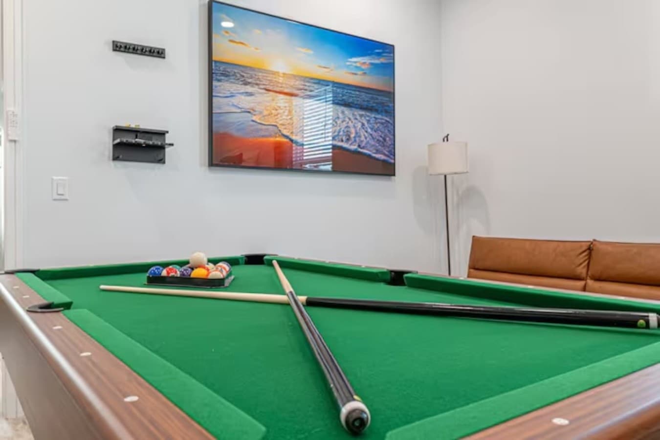 A fun pool table and large smart TV located upstairs in the home