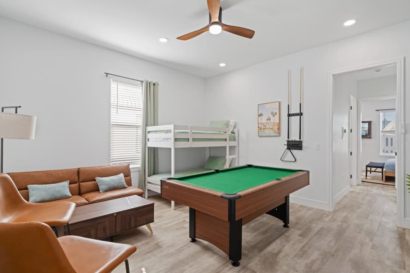 A second living space is upstairs in the home, featuring a pool table and a large smart TV