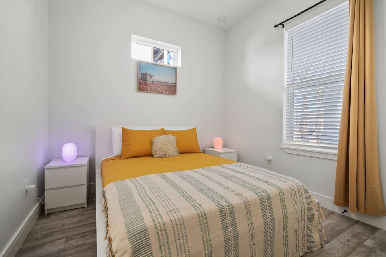 The other queen bedroom located on the main level of the home with a smart TV