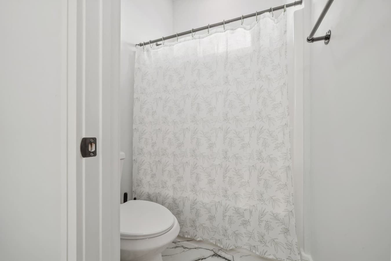 A spacious bathroom with a bath tub located upstairs in the home