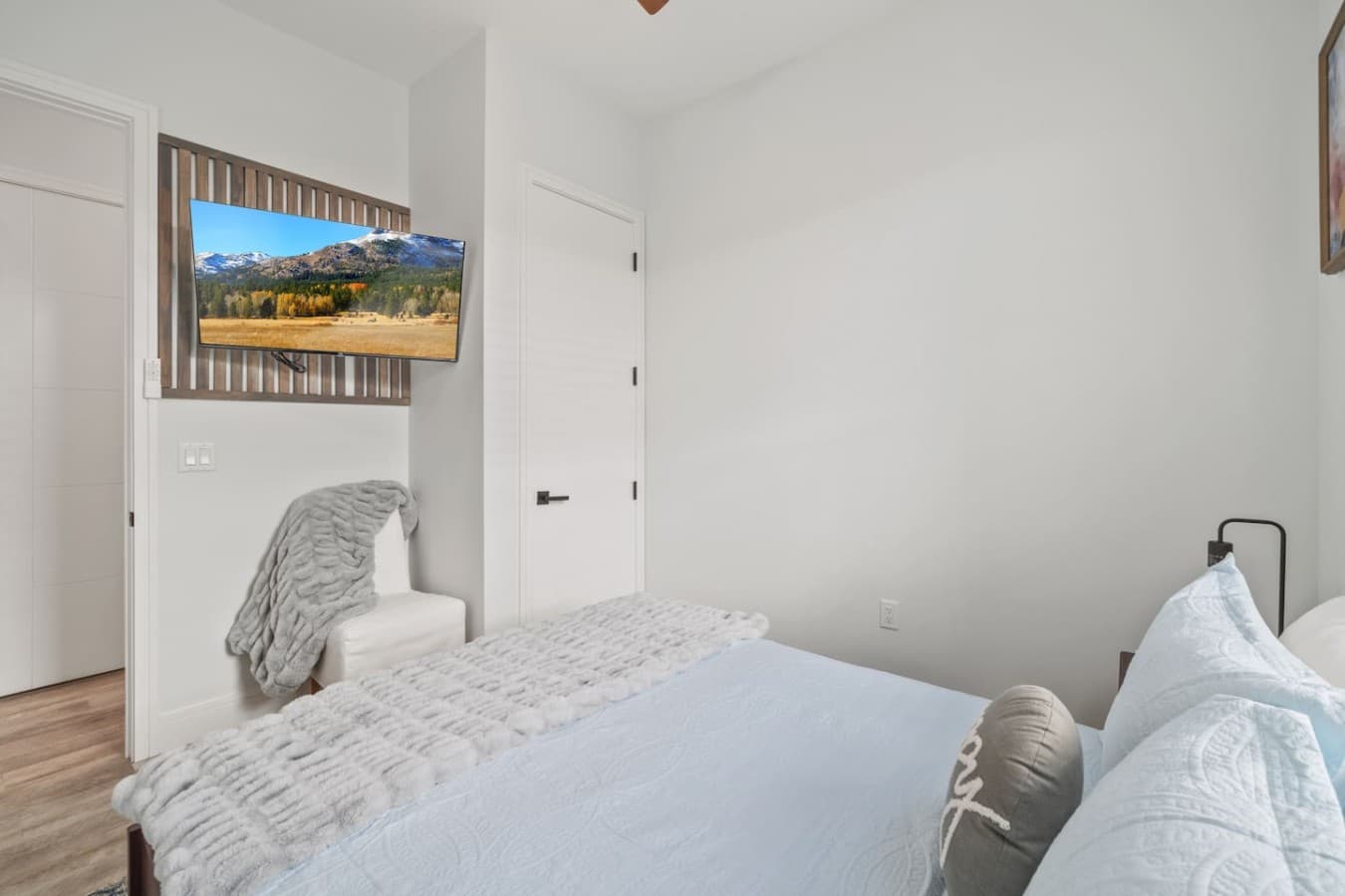 Queen bedroom located on the main level of the home with a smart TV
