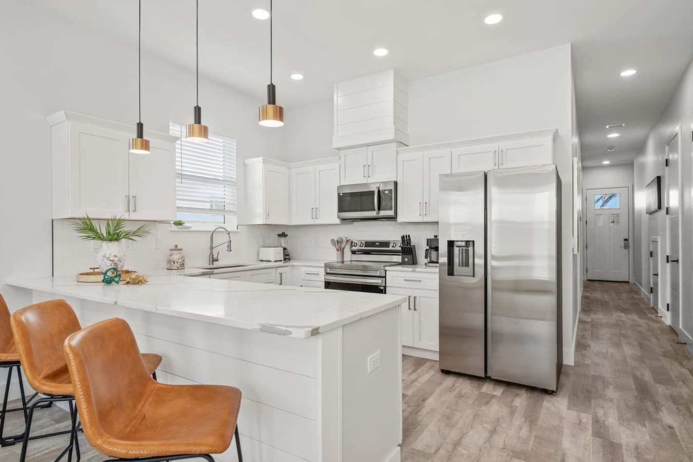 A modern kitchen with high-end finishes including granite countertops and stainless steel appliances