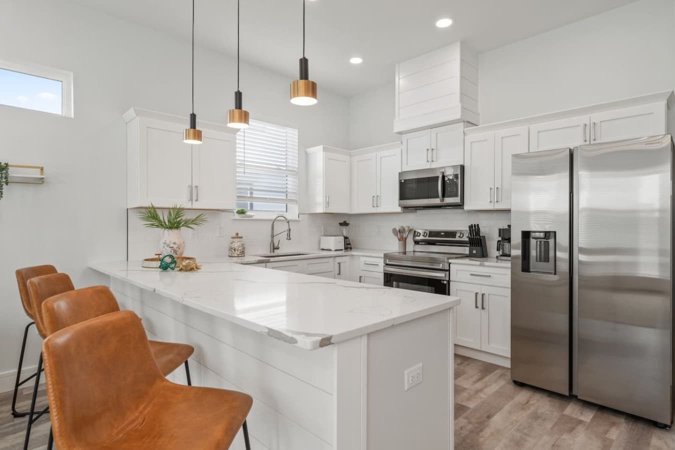 A modern kitchen with high-end finishes located just off the living room on the main level