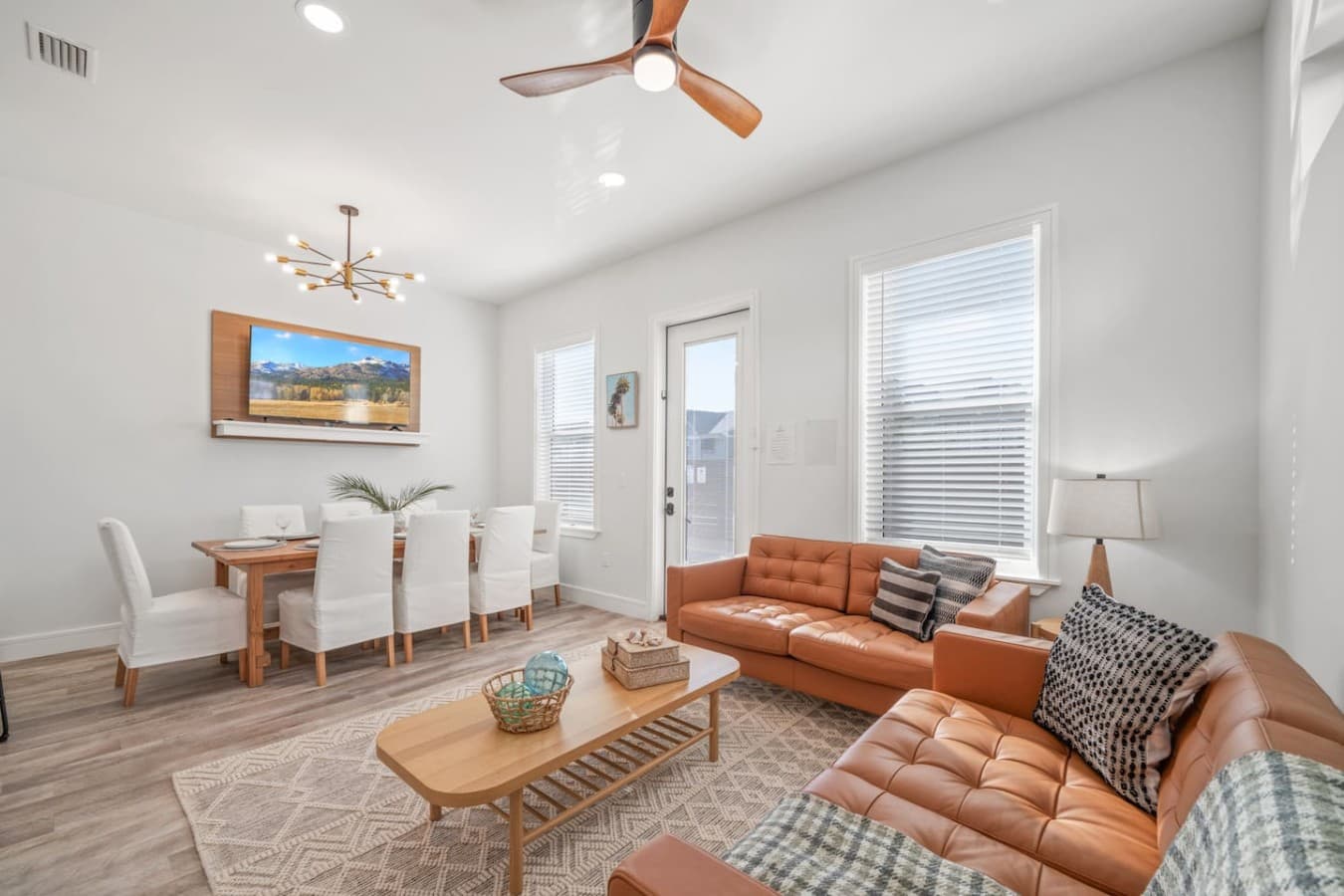 A comfortable living room with leather sofas located on the main level