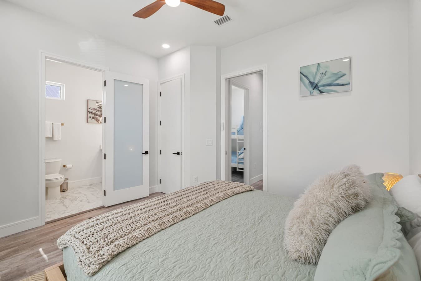 Master bedroom with en suite bathroom located upstairs in the home