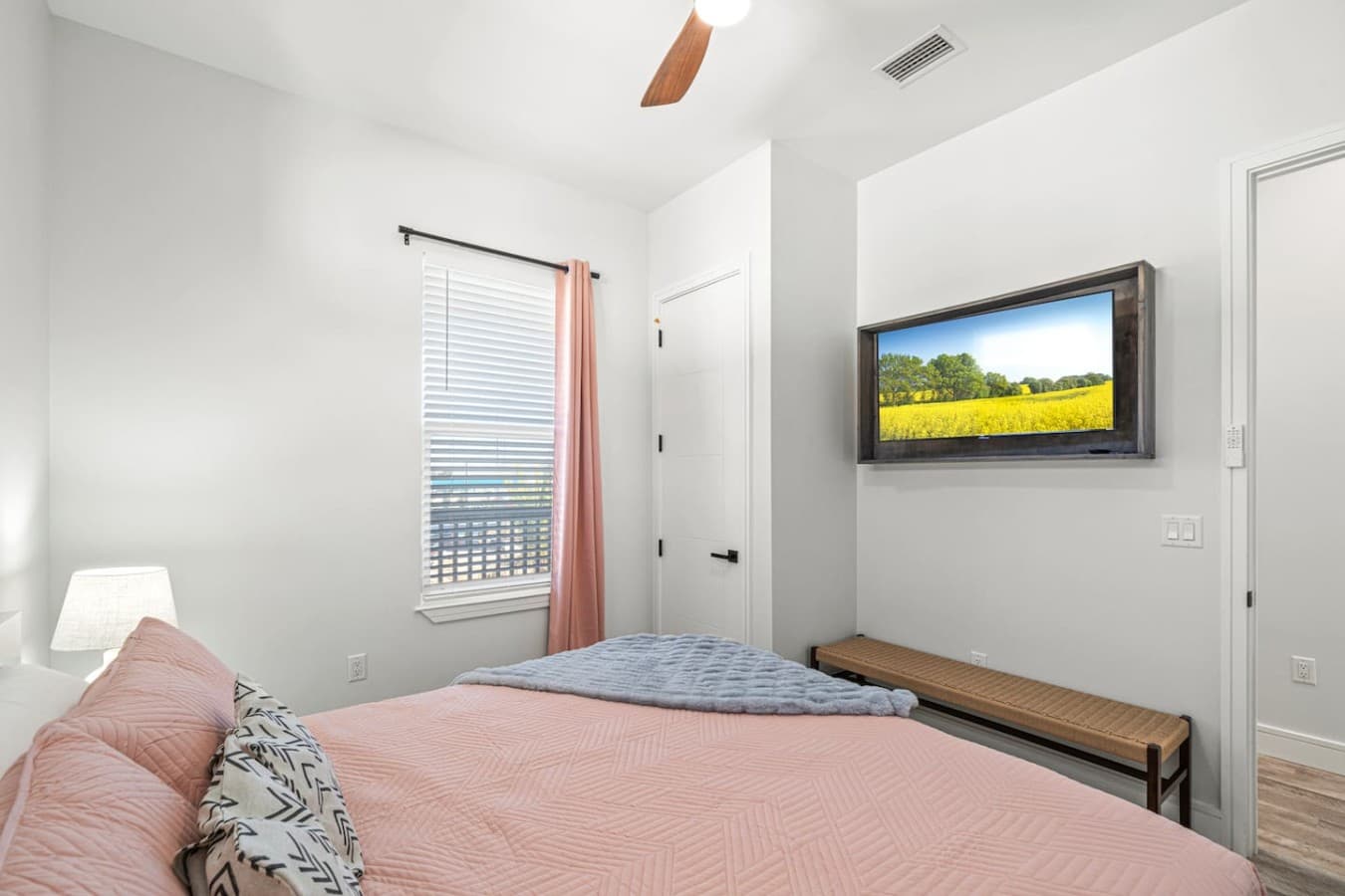 The second king bedroom located upstairs in the home with a large smart TV