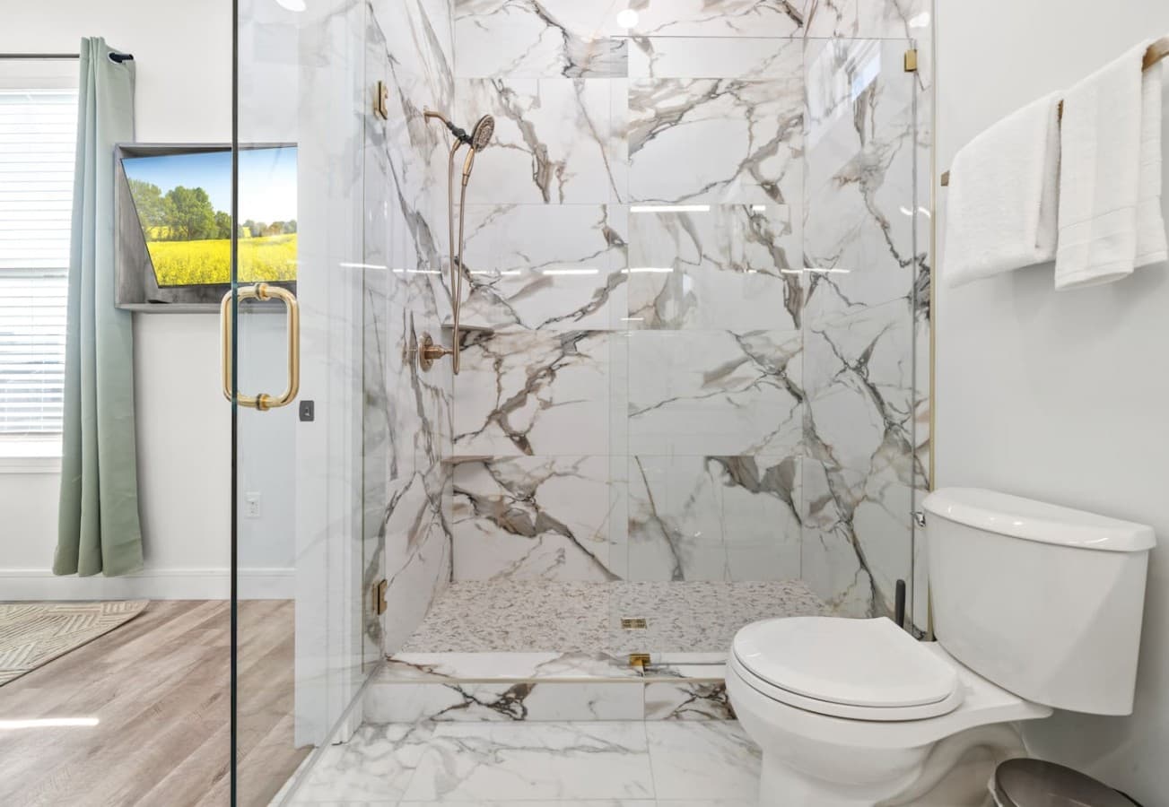 A custom-tile walk-in shower en suite to the master bedroom upstairs