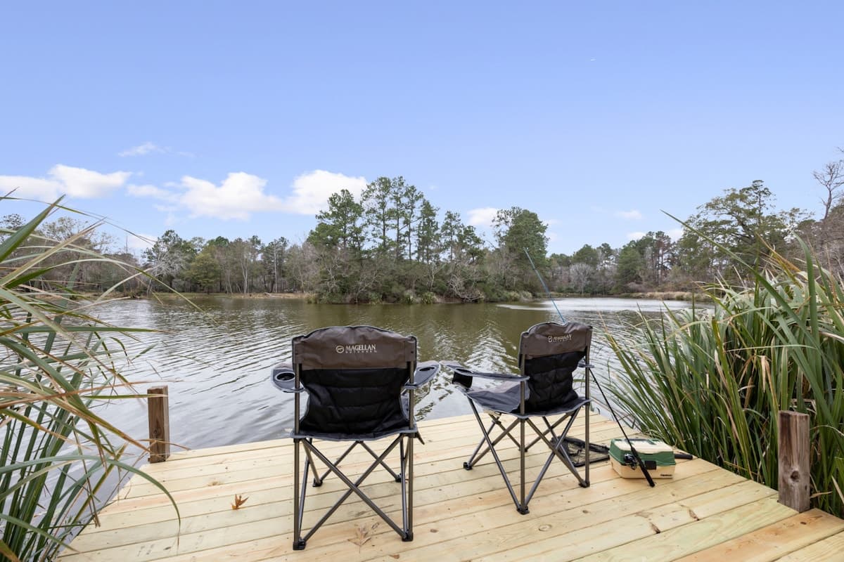 Two lakeside chairs on a private dock, offering a calm spot to relax, fish, and take in the peaceful view