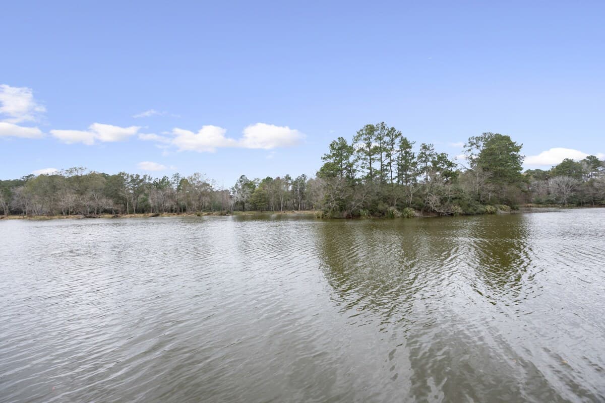 Stunning lakefront views from the property’s dock, surrounded by trees—perfect for peaceful mornings, sunset reflections, and enjoying the water right at your doorstep.
