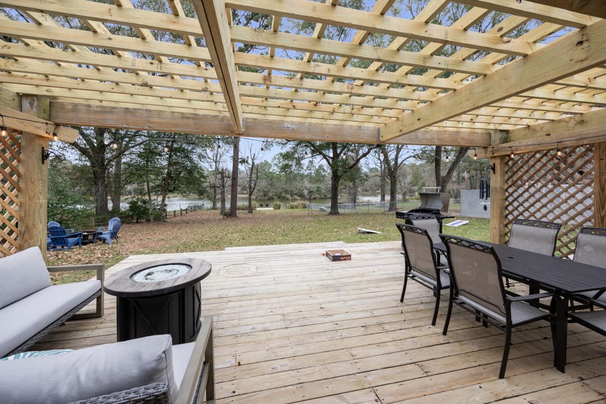 Outdoor deck with a grill, dining area, and lounge seating, perfect for easy meals and peaceful nights outside.