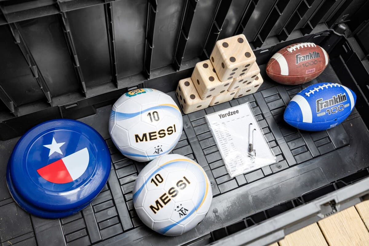 Outdoor games ready to go—soccer balls, footballs, frisbee, and yard games for easy fun between meals, sunsets, and downtime.