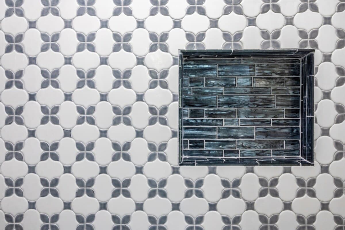 Close-up of the shower’s patterned tile and built-in niche, highlighting the thoughtful design and clean finish.