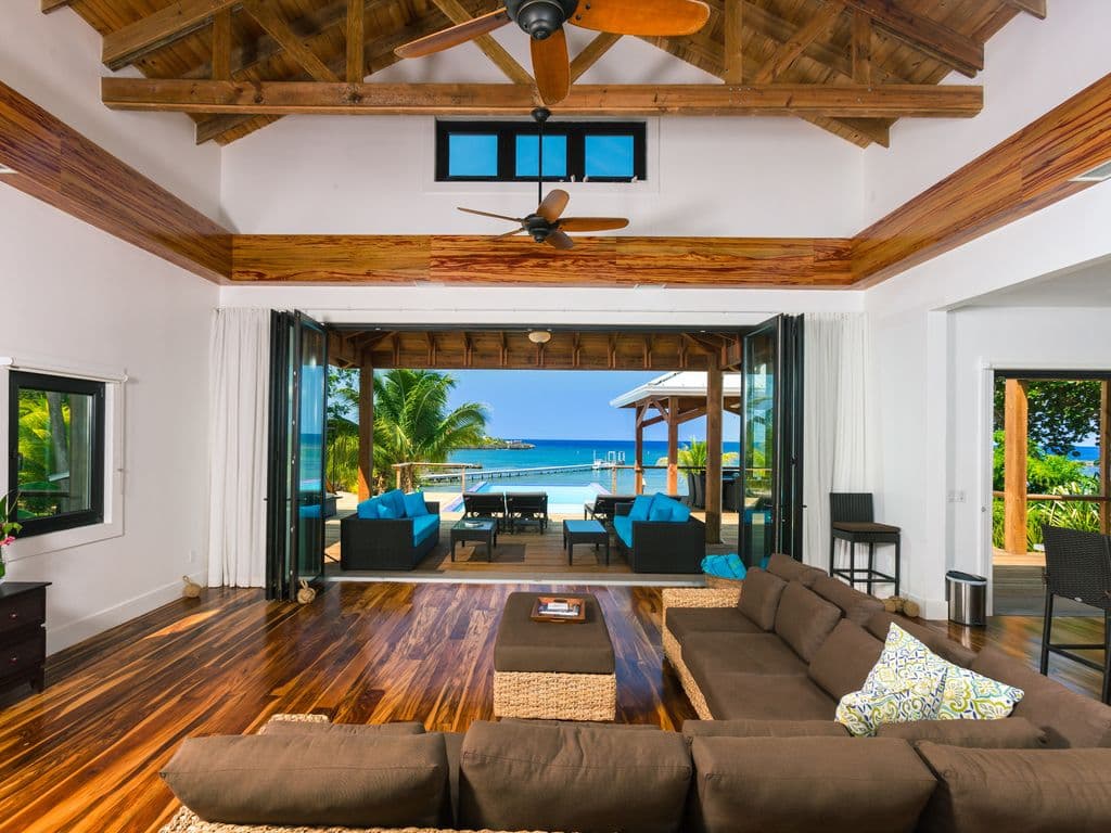 The Vivaro Beachfront great room is the crown jewel of the 5,500 sq. ft. villa, designed as a massive, open-concept hub for socializing. It seamlessly blends a high-end chef’s kitchen with expansive living and dining areas.