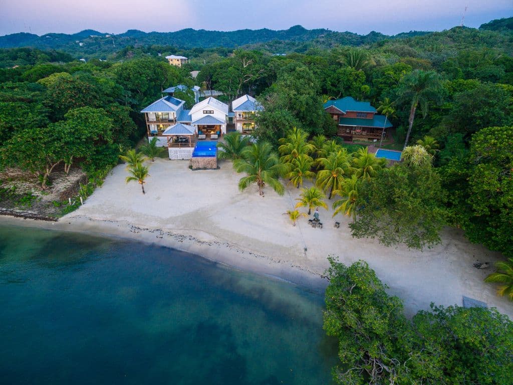 From an aerial view, you can see how the property is tiered. You have the infinity pool and tanning ledge on the upper level for those "limitless" ocean views, and the private beach just steps below for a classic toes-in-the-sand island experience.