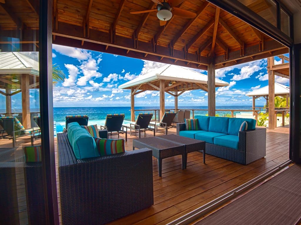 The veranda at Vivaro is a masterclass in indoor-outdoor living 🏠, serving as a shaded transition between the cool interiors and the tropical sun. It is an expansive, covered deck that effectively doubles the living space of the villa.