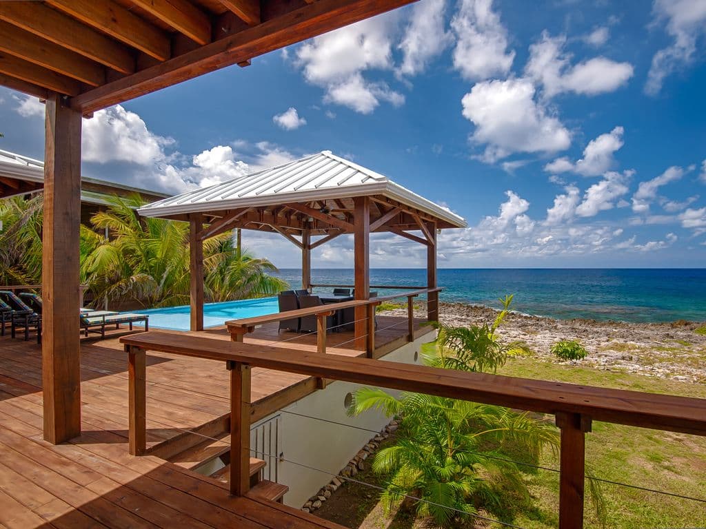 Perched on an elevated ridge, the Three Bedroom King deck offers a panoramic "birds-eye" view of the Caribbean. 🌊 Watch the turquoise reef 🪸 shift into deep indigo as the infinity pool reflects the golden island sunset. Pure tropical immersion. 🌅🍹