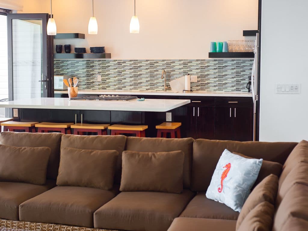 🌿 Our massive, deep-seated sectional is the heart of the Great Room. 🛋️ Perfectly positioned for movie nights or admiring the Caribbean view, it offers plenty of space for the whole group to relax in air-conditioned comfort. 🌊✨