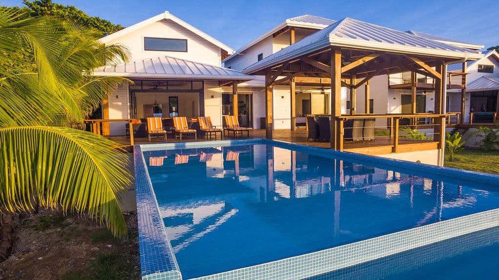 🌅 From the pool, the Great Room looks like a glowing sanctuary. 🏠 The open glass walls perfectly frame the kitchen and lounge, ensuring you're never disconnected from the group while enjoying a sunset swim. 🌊✨