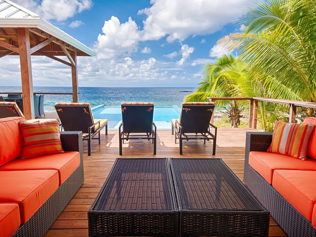 Our infinity edge pool creates a seamless horizon where crystal water meets the deep blue sea. It’s the ultimate spot to soak in the sun while the Caribbean feels close enough to touch. 🌊✨