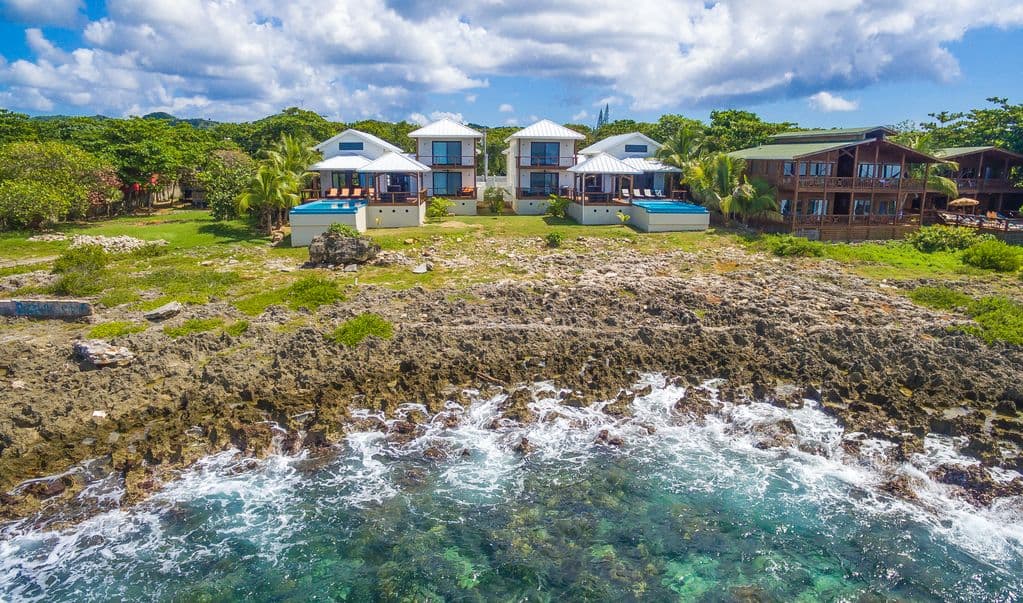 An aerial view reveals Vivaro Oceanfront as a private island sanctuary. Watch the turquoise Caribbean surf crash against the shore, mere steps from your dual infinity pools. It’s a stunning blend of modern luxury and raw coastal beauty. 🛸🌊