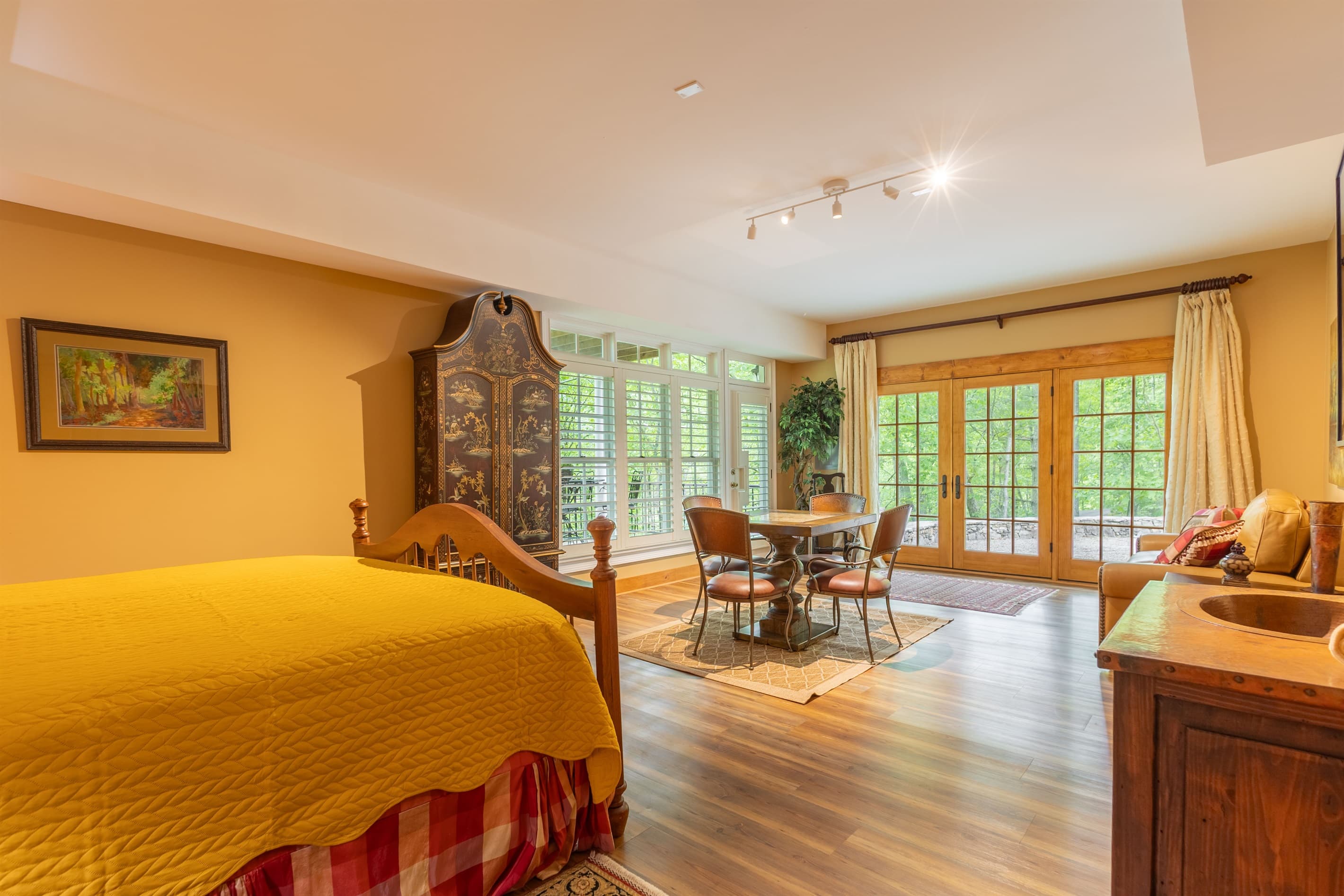 French doors fill the lower-level suite with natural light and create easy access to the peaceful outdoor space just beyond the room.