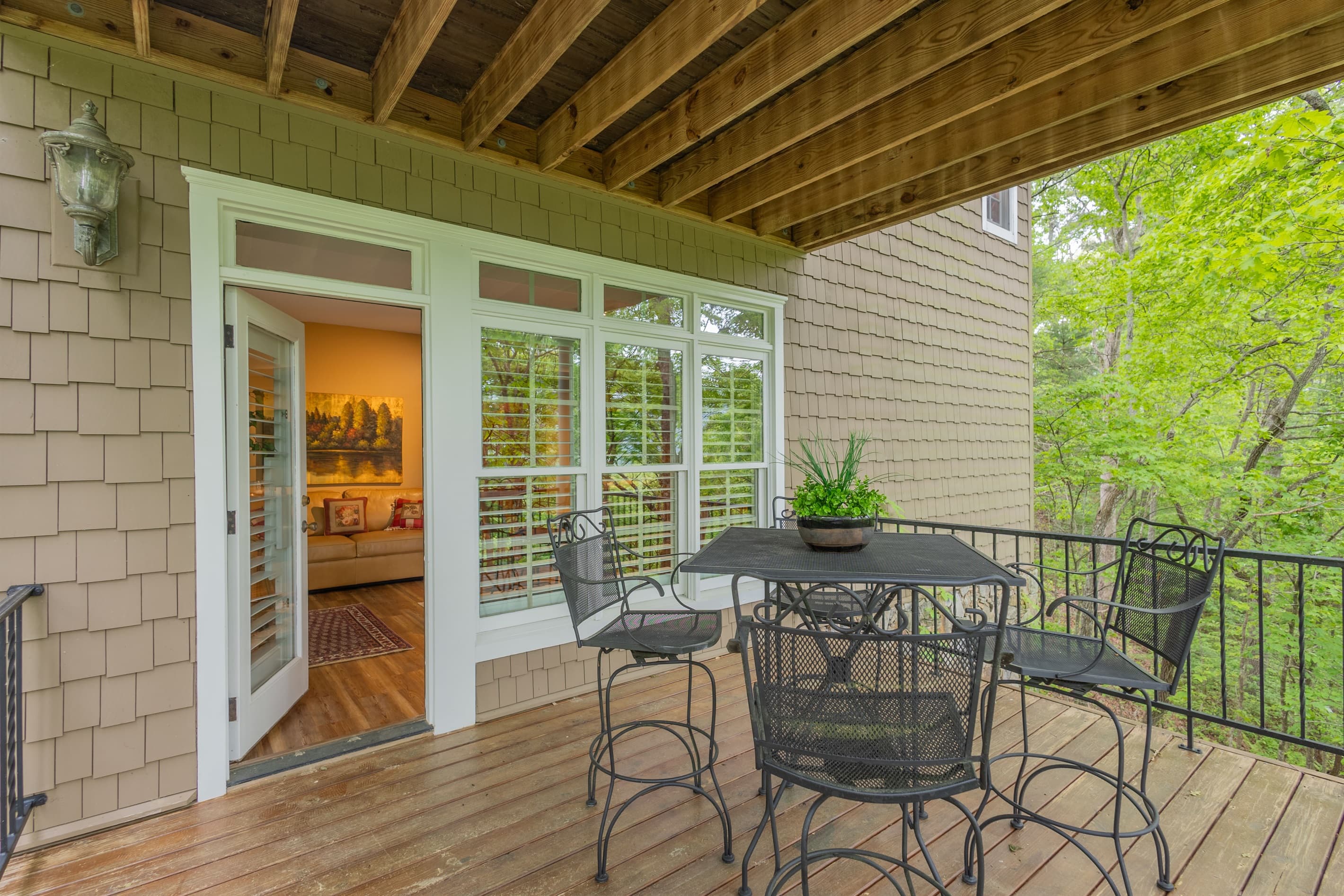 Step right outside from the lower-level suite and enjoy easy access to the covered deck nestled among the trees.