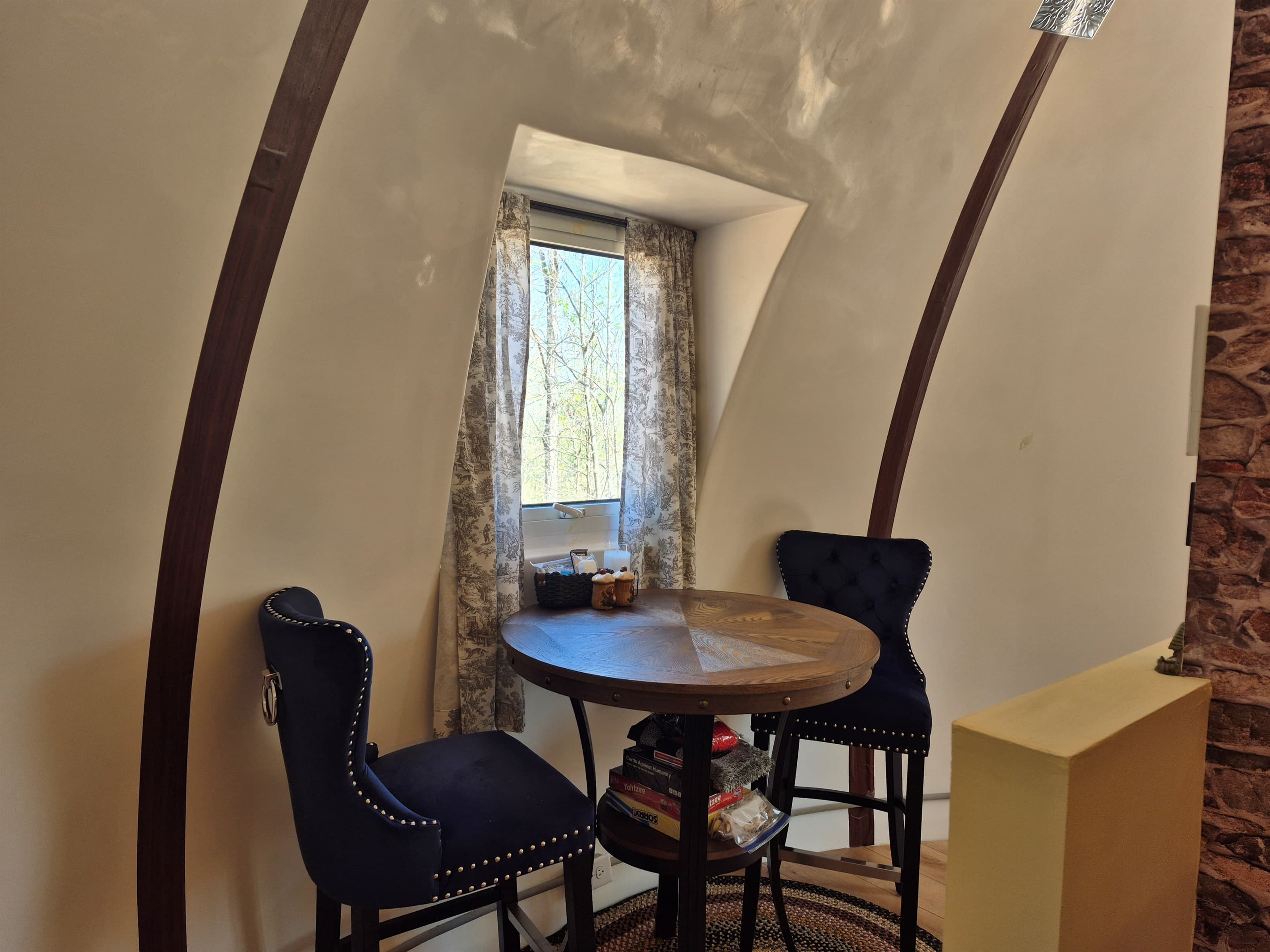 Indoor dining for 2 with a window view the surrounding woods