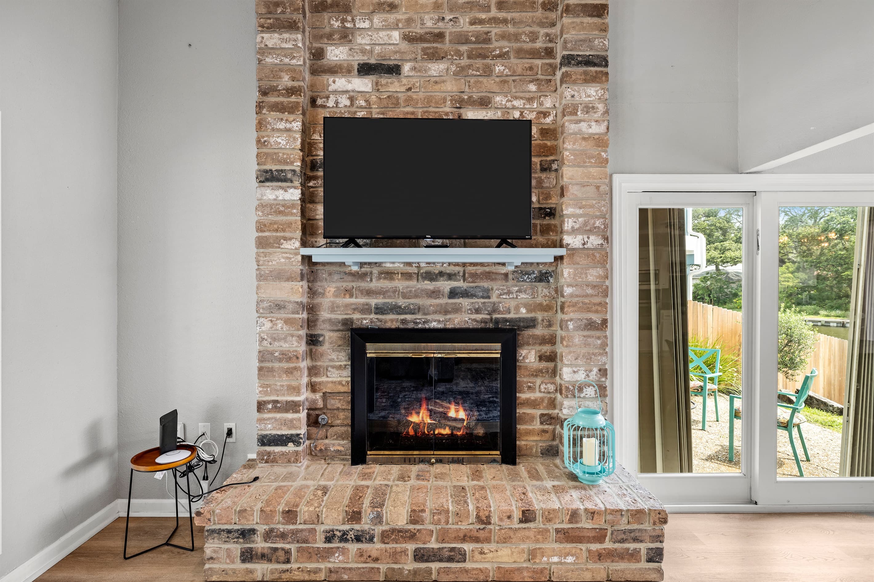 Gather around the exposed brick fireplace at Lakeview Landing — cozy evenings with the whole group after a full day on Madeline Lake.