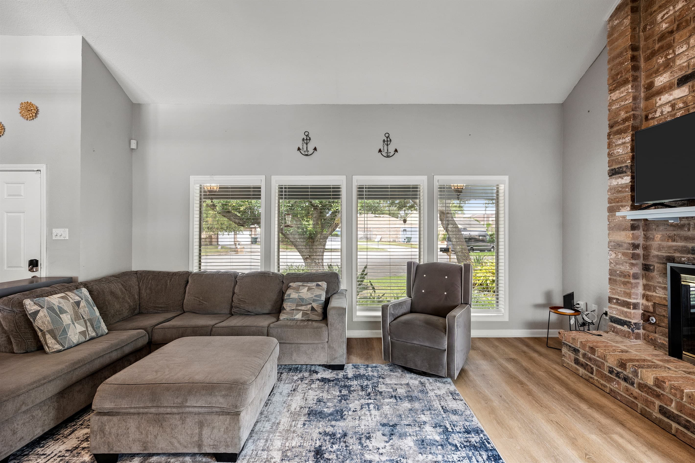 Spacious living room at Lakeview Landing — nautical accents, plush sectional, and natural light set the perfect Galveston vacation mood.