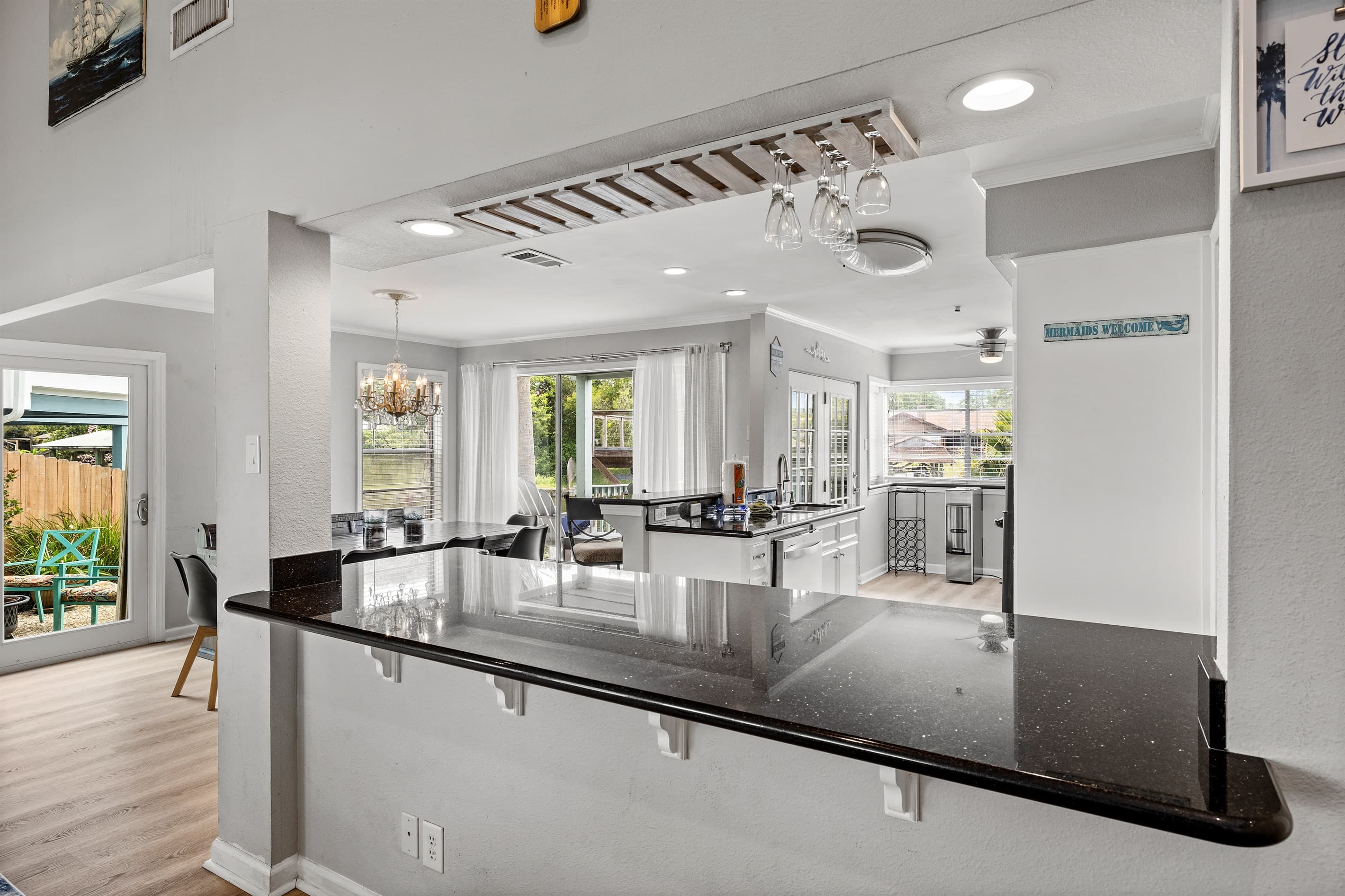Bright, open kitchen at Lakeview Landing — black granite countertops and white cabinets make this space as beautiful as it is functional.
