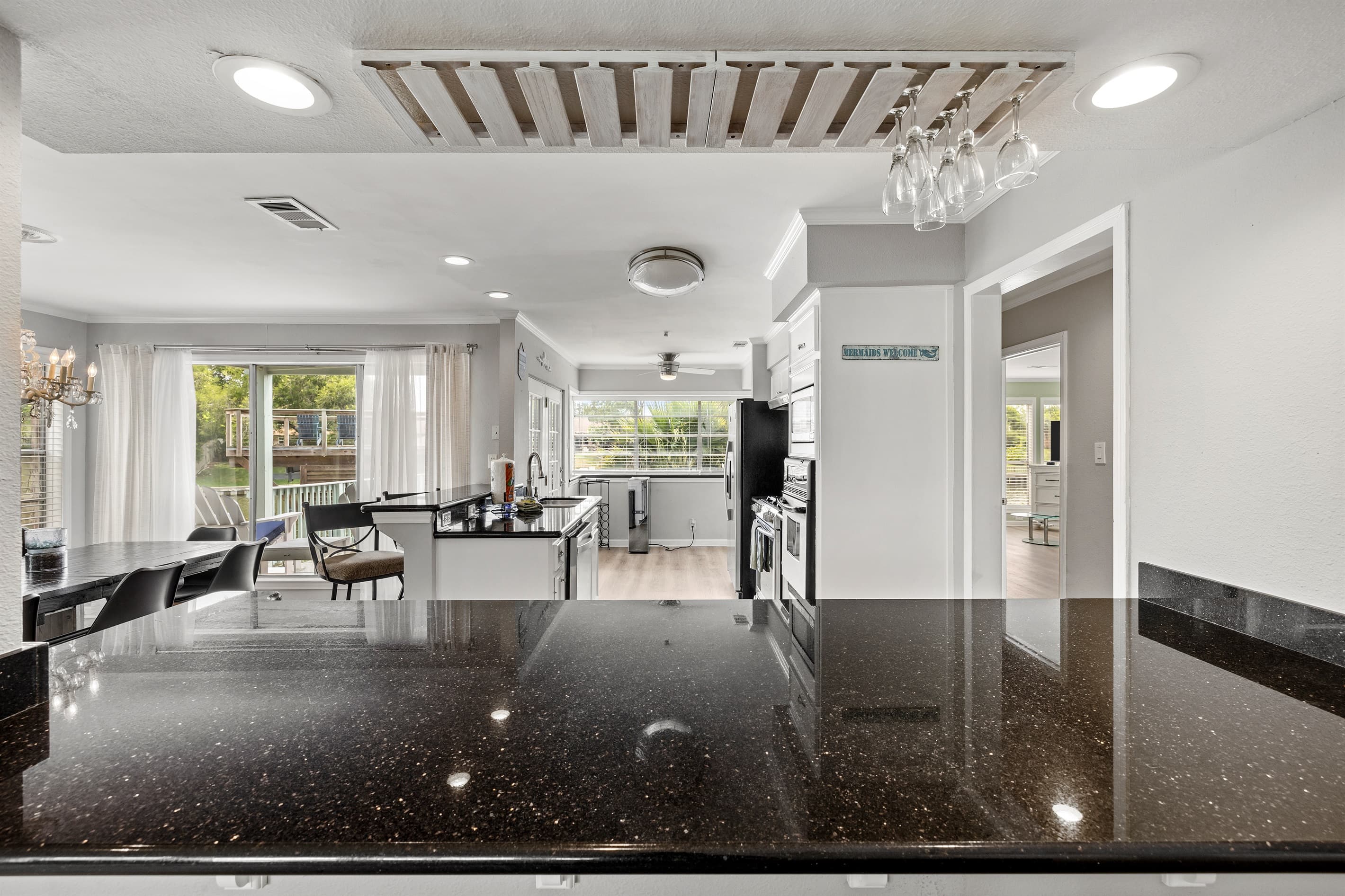 Open-plan kitchen and dining at Lakeview Landing — the granite island anchors the space where your group gathers morning to night.