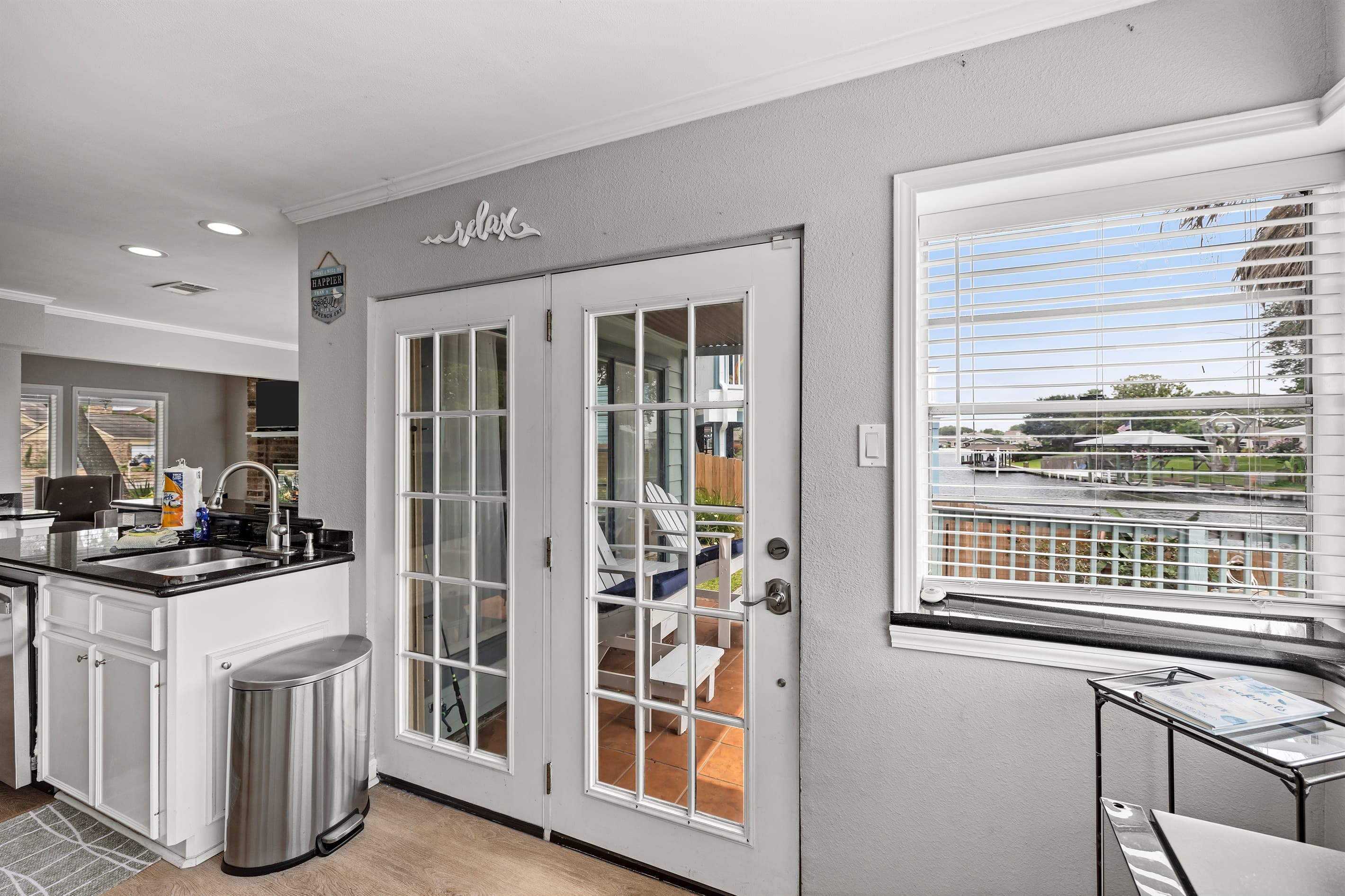 French doors from the kitchen open directly onto the multi-level deck at Lakeview Landing — step outside to Madeline Lake and beyond.