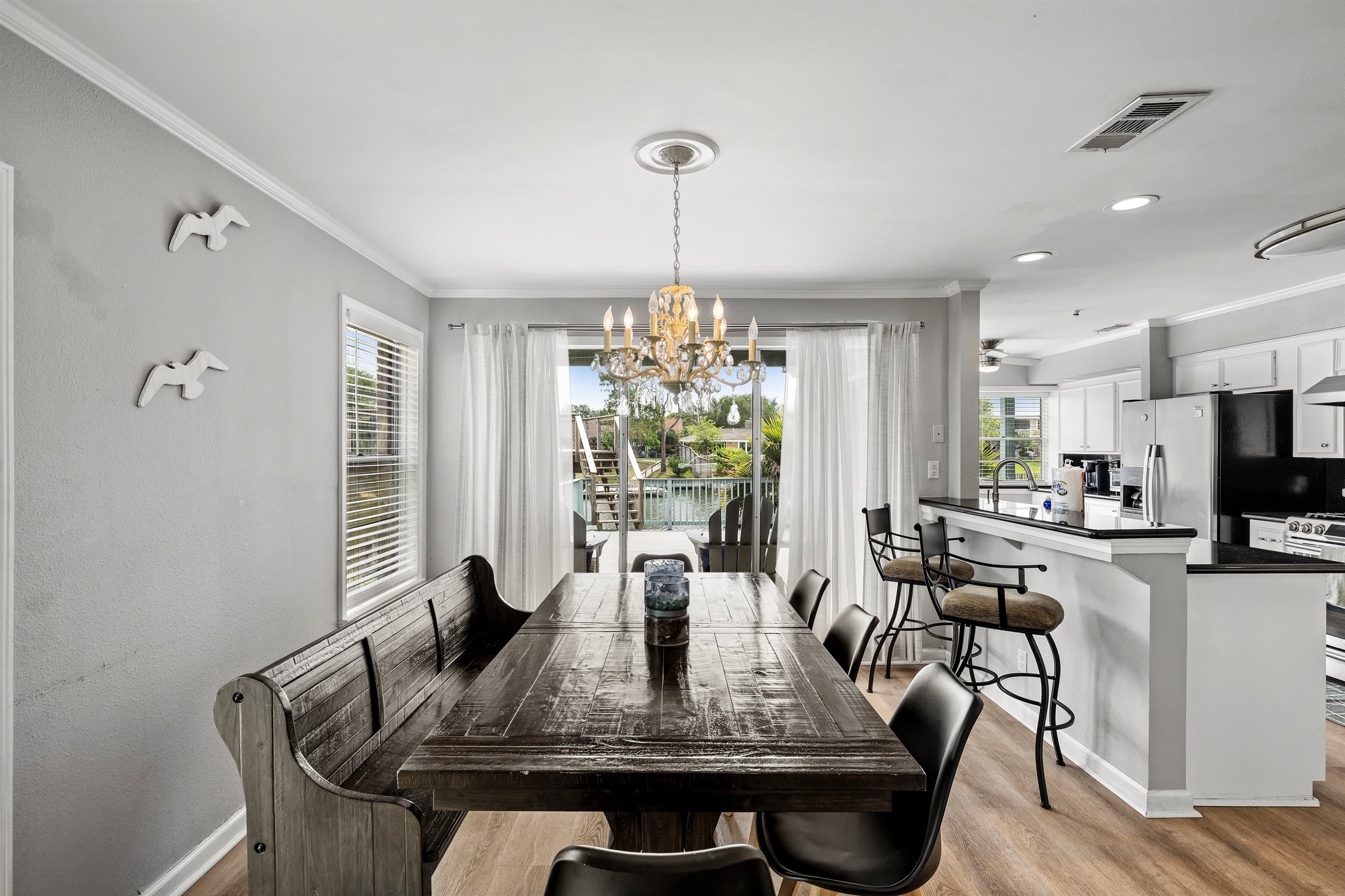 Farmhouse dining at Lakeview Landing — long table seats the whole group with Madeline Lake visible through the windows.