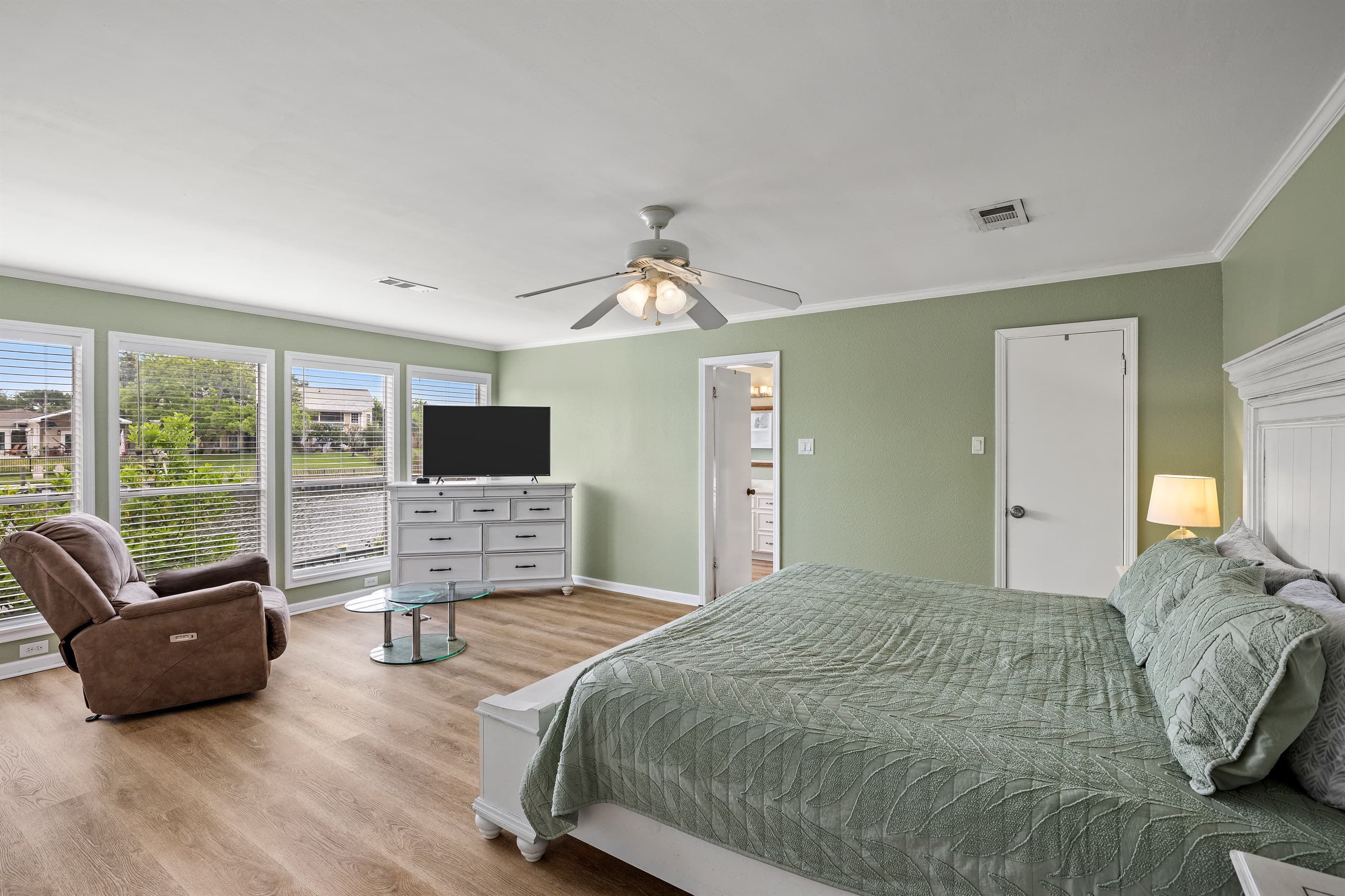 Master bedroom at Lakeview Landing — king bed, natural light, and peaceful Madeline Lake views from this serene downstairs retreat.