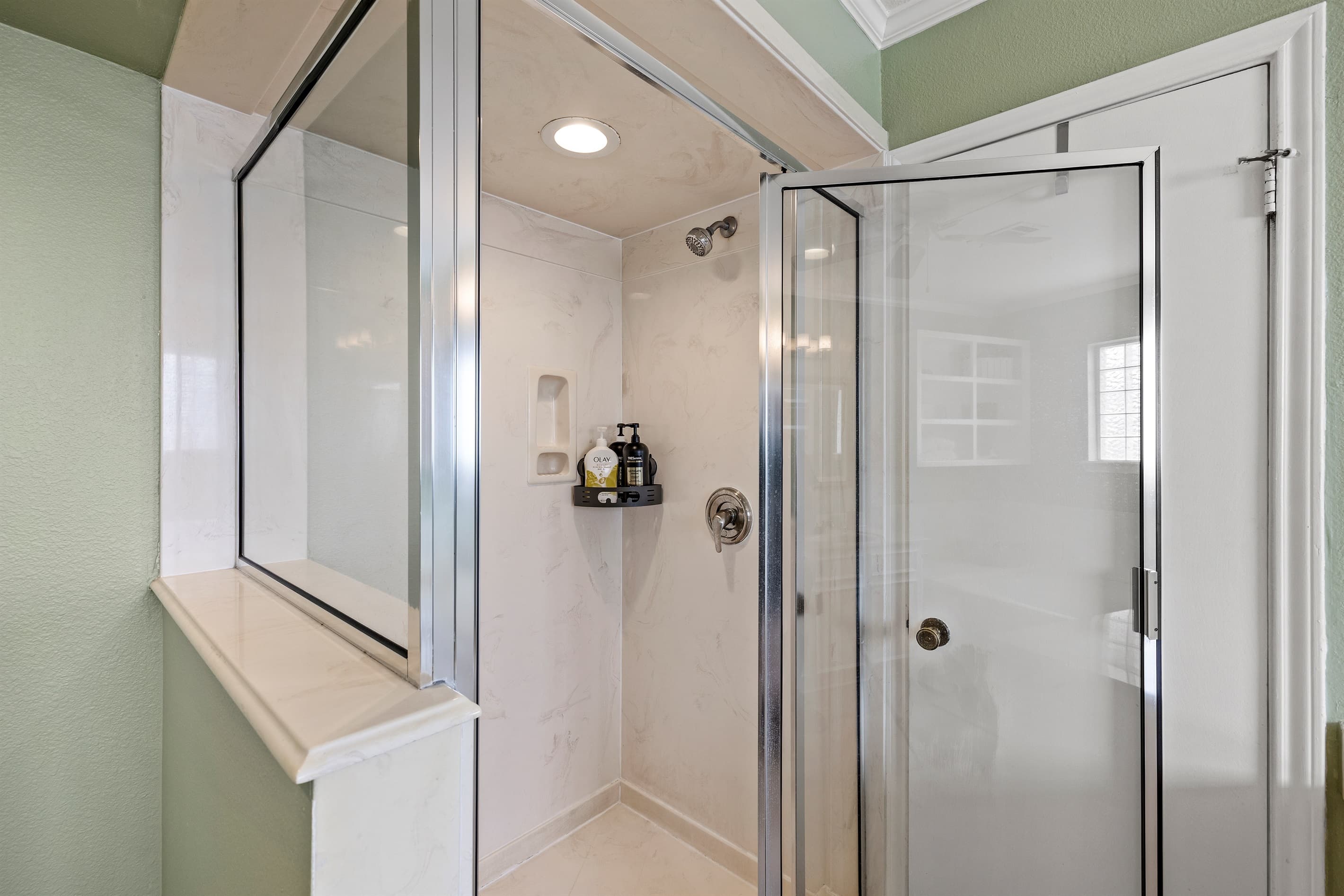 Walk-in shower in the master en-suite at Lakeview Landing — beautifully tiled, spacious, and a refreshing start to every Galveston morning.
