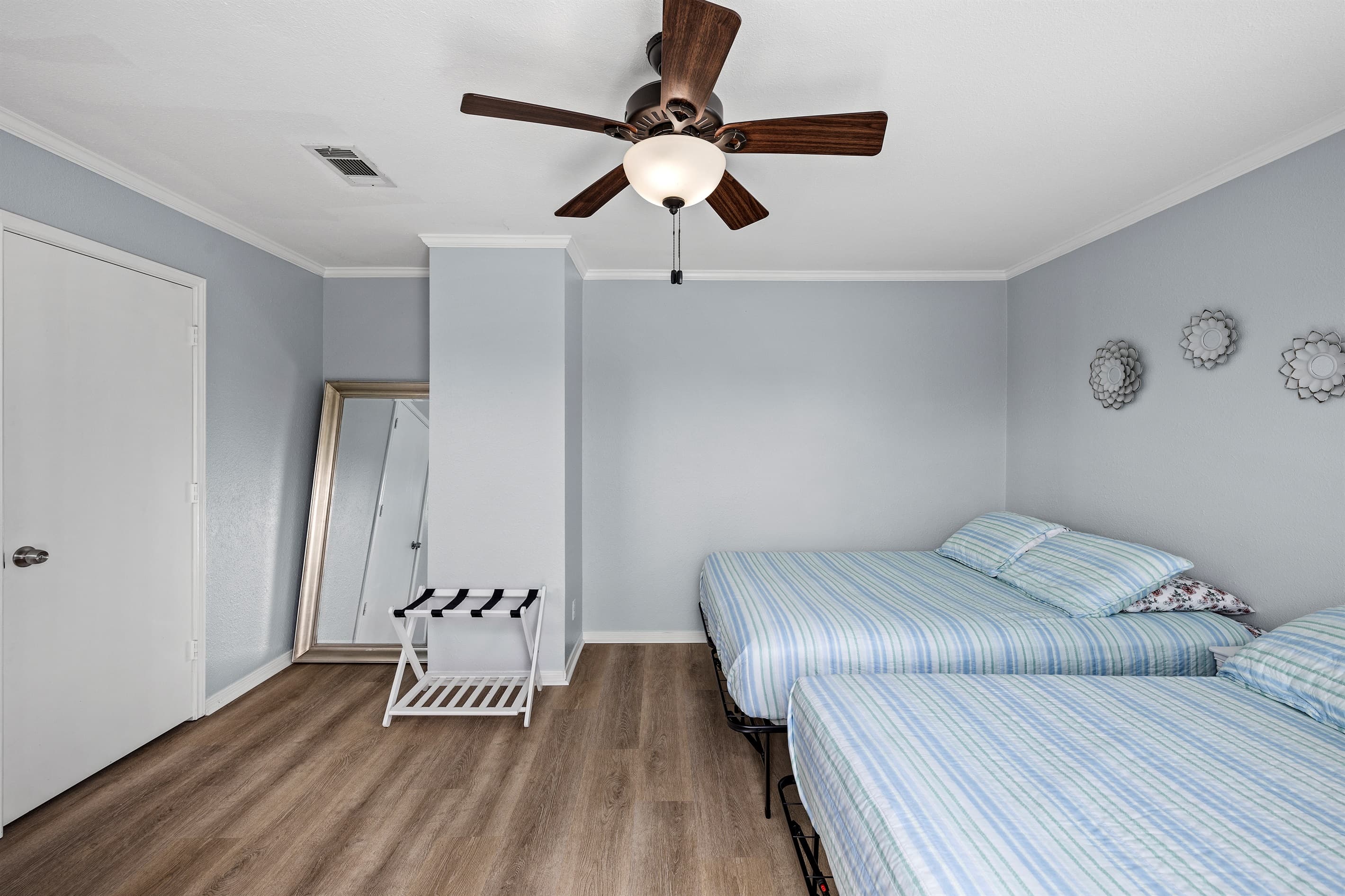 Bedroom 2 at Lakeview Landing — comfortable upstairs retreat with ceiling fan and quality bedding for a restful Galveston night's sleep.