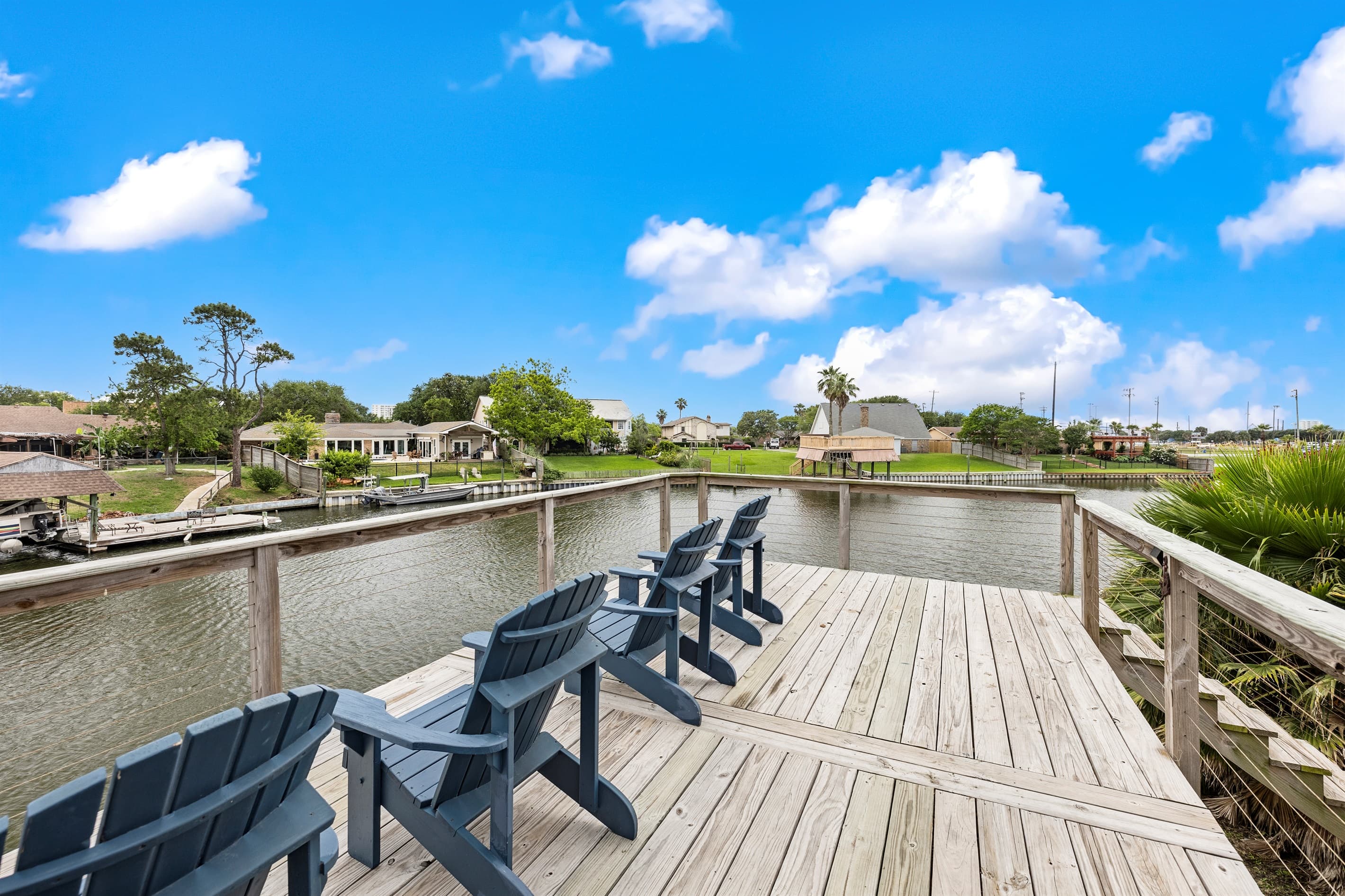 Looking out over Madeline Lake from Lakeview Landing's private dock — calm waters, blue skies, and a front-row seat to Galveston waterway living.